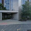 Man climbing in and out of dumpster at Geneva Tower