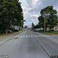 Man stumbling and swinging wrench near intersection