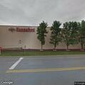 Disabled vehicle with tow truck at store entrance