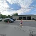 Officer checks on person in auto shop parking lot