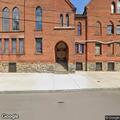 People loitering at church doorway on Hudson Avenue