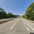 Pedestrian walking on Spaulding Turnpike bridge