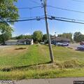 Person experiencing severe back pain at apartment
