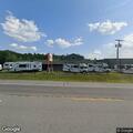 Person fallen with head injury at Campers Inn parking lot