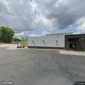 Vehicle hits building near propane tanks in lot