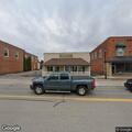 Two men fighting behind Millington Insurance