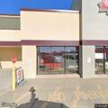 Disabled vehicle with tow truck at store entrance