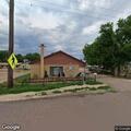 Officer checks on shirtless man near Cowboy Inn