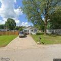 Couple arguing and throwing objects outside home