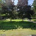 Unknown person in bushes with flashlight at home