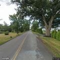 Woman lying on road with wagon at Oak Orchard River Rd