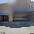 Person seated near Dollar Tree in black shirt has medical issue