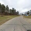 Abandoned car partially blocking roadway