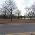 Man flailing on ground behind gazebo at Mill Creek Park