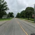Person unresponsive laying on ground at street corner
