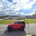 Agricultural vehicle blocking roadway near bank