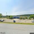 Male found lying beside vehicle at high school