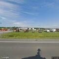 Elderly woman with breathing difficulty at farm supply