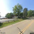 Dog blocking traffic lane near Green Lake Manor