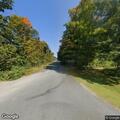 Tree down with wires near covered bridge in Orford