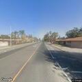 Person cutting overhead wire on city street