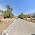 Men flagging traffic by vehicle hazard on NC Highway 210