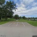 Person sleeping under gazebo at North Park