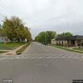 Woman walking in road at intersection in Ettrick