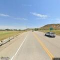 Grass fire between railroad tracks and highway