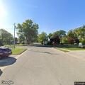 Person sleeping in minivan at library parking lot