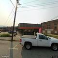 Smoldering mulch pile in front of coffee shop