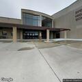 Officer checks vehicle in school parking lot