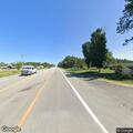 Pedestrian walking in roadway near grocery store