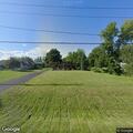 Suspicious person sitting in grass on Lakeshore Road
