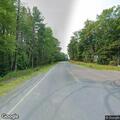 Tree on power line sparking at road intersection