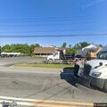 Three-car crash with fluid leak in front of business