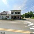 Female sleeping in car at old restaurant in Bingham