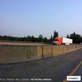 Man yelling alone on Boone Bridge with cardboard