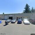 Person experiencing back pain near industrial way