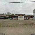 Man and woman yelling behind business on North Main