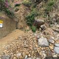 Rider dangling from tree near cliff in high-angle rescue