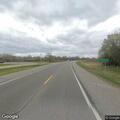 Red work truck swerving on Highway 71 near milepost 179
