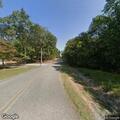 Controlled burn spreads into woods behind home