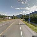 Four-wheeler with passenger on highway near glacier