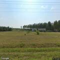 Grass fire spreading toward pole barn near house