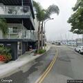 Naked man running in street near apartments