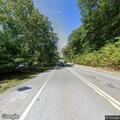 Man walking in and out of road on Littleton Road