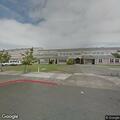 Woman yelling beside vehicle near high school