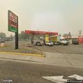 Suspicious man in mask near gas pumps
