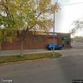 Person sleeping in parking lot at business